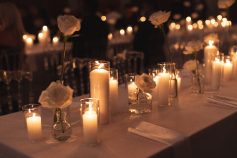 Beautiful, candlelit table setting at an event, such as a wedding. 