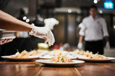 Closeup of professional chef plating dish in restaurant kitchen. Gala Event Planning - Cultivate Event Planning 