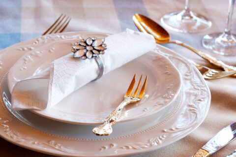 Beautiful table setting. Table setting with golden cutlery and crystal glasses. Private special event planning - Cultivate Event Planning