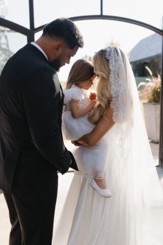 Bride and groom with daughter in bride's arms on wedding day. Wedding Planning Oklahoma City - Cultivate Event Planning